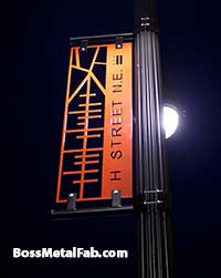 Custom street light pole signs at night