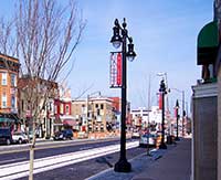 Custom light pole signs at night in neightborhood